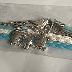 Brand New in Package corded bracelet cute charms. Each one come with happies